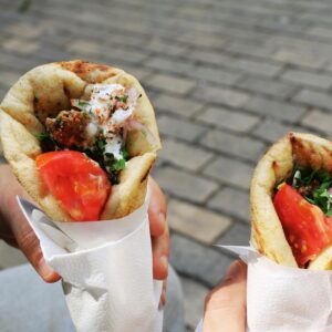 Two fresh gyros with tomato and herbs, perfect Greek street food for a sunny day.